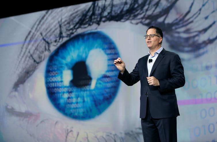 Michael Dell giving a presentation in front of a giant eye